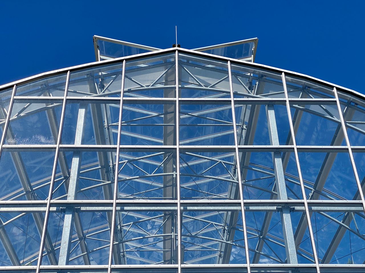 Clear sky reflection in a modern glass building structure, Überlingen, Germany.